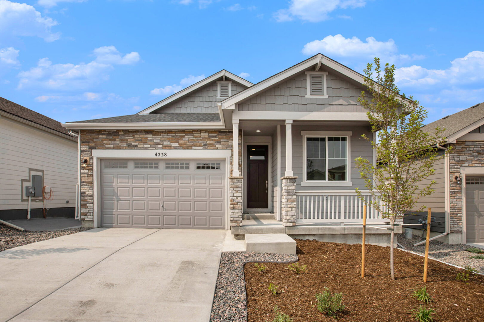 A house with a garage and driveway in front of it.