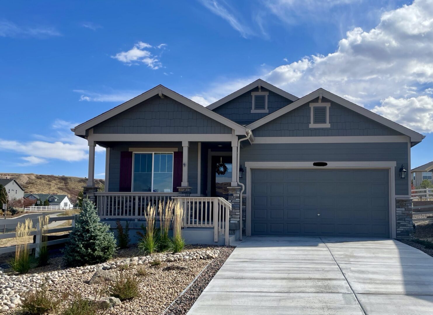 A house with a porch and garage in the front yard.